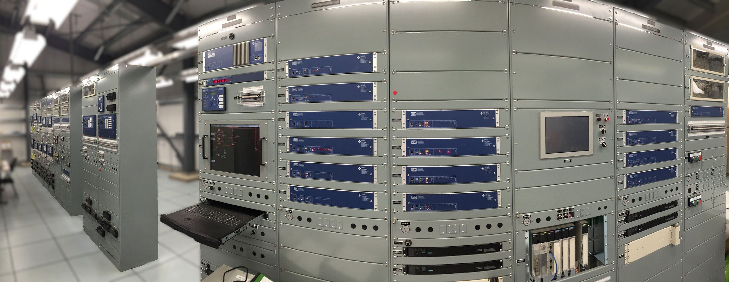 Rows of protection and control panels in a substation control room